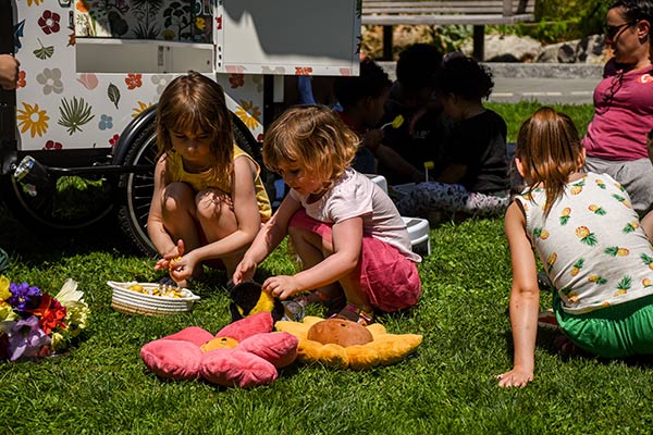 Kids playing at the imagination station on the lawn