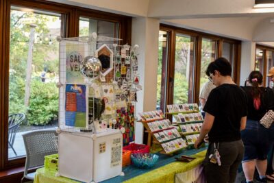 A visitor checking out a vendor table at the Pride Celebration