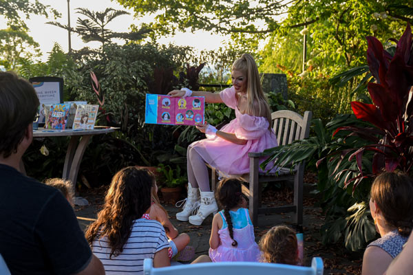 Drag queen reading a book aloud
