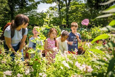 Education director, Marissa, with kids in the Climate Garden