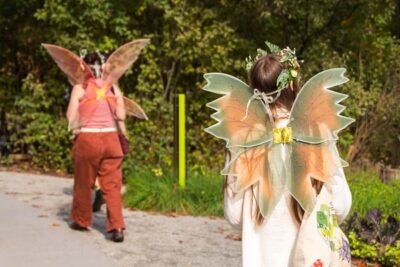 Visitors dressed as fairies walking near the Cottage Garden
